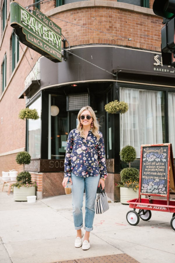 Chicago blogger Bows & Sequins wearing a Rebecca Taylor floral blouse from Nordstrom Rack, Illesteva sunglasses, Vineyard Vines straight leg boyfriend jeans, and Sam Edelman white loafers, with a Clare V striped bag at the Spinning J.