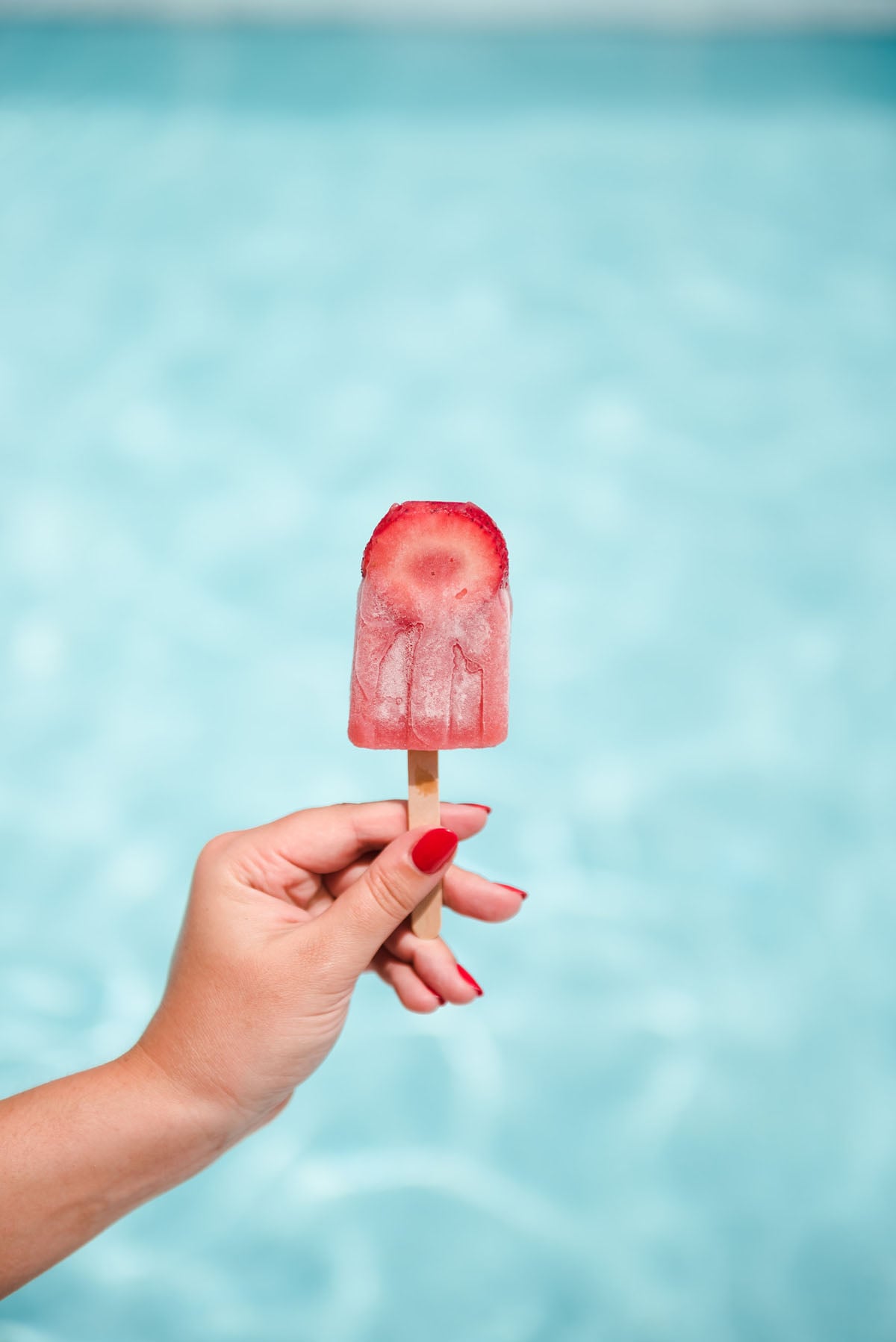 How to make boozy strawberry and rosé popsicles.