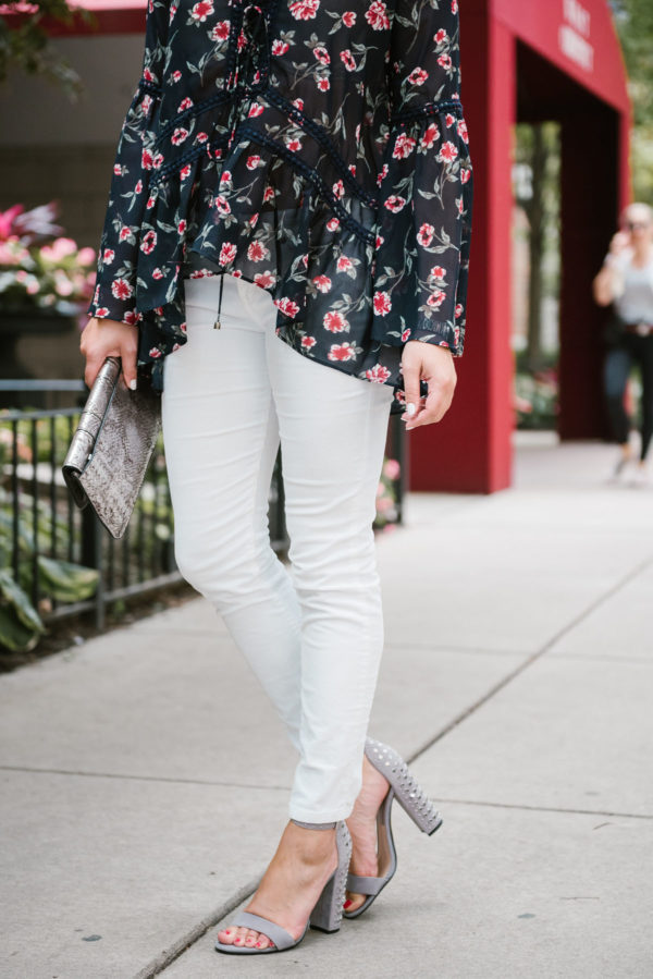 Chicago fashion-focused blogger Bows & Sequins wearing white corduroy jeans and Dolce Vita studded heels.