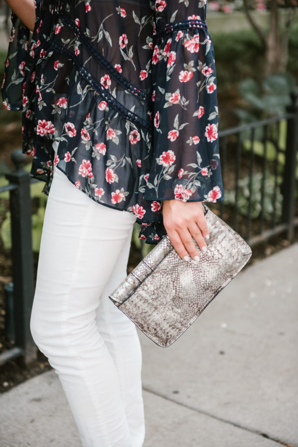 Bows & Sequins wearing Vineyard Vines white corduroy jeans and holding a metallic silver clutch.