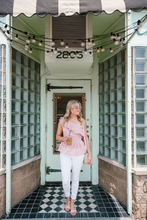 Chicago blogger Bows & Sequins wearing a J.O.A. pink eyelet top, Old Navy white denim jeans, pom pom sandals, and a Clare V straw bag.