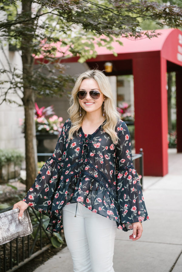 Bows & Sequins wearing Gucci aviators and a Moon River flare sleeve floral blouse.
