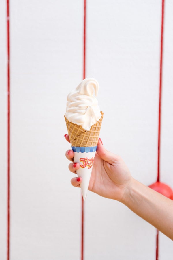 Bows & Sequins holding a soft serve ice cream cone.