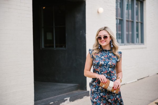 Bows & Sequins wearing pink Nordstrom sunglasses and blue Kenneth Jay Lane Bon Bon earrings from Tuckernuck with a Les Petites silk midi dress and a Vineyard Vines wicker clutch.