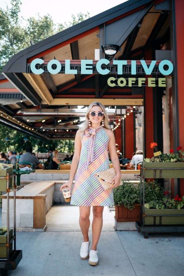 Chicago lifestyle blogger Bows & Sequins outside Colectivo Coffee in Chicago, wearing a J.Crew dress, perforated espadrilles, and pink sunglasses, with a pom pom clutch.