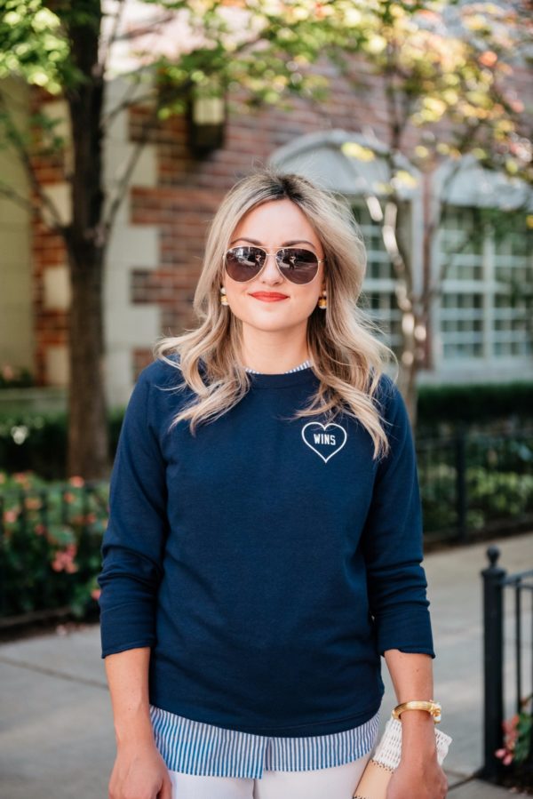 Chicago-based fashion-focused lifestyle blogger Bows & Sequins wearing Gucci aviators, Julie Vos pearl earrings, an Old Navy Love Wins graphic sweatshirt, and a Julie Vos gold cuff.