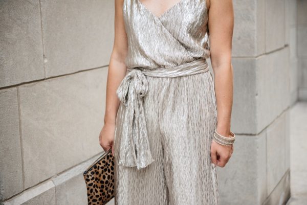 Fashion-focused blogger Bows & Sequins wearing a metallic gold Plissé tie-waist jumpsuit from Nordstrom and pavé bangles.