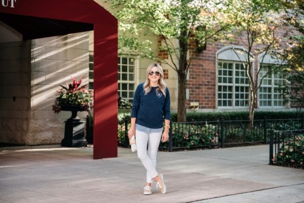 Bows & Sequins wearing Old Navy white denim, a Love Wins graphic sweatshirt, leopard print sneakers, and Gucci aviators.