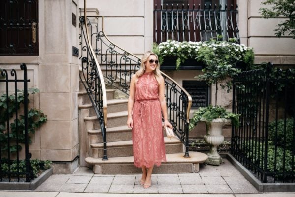 Chicago-based fashion-focused blogger Bows & Sequins wearing a pink Wayf dress, gold Gucci aviators, a metallic Marc Jacobs pouch, and ankle strap heels.