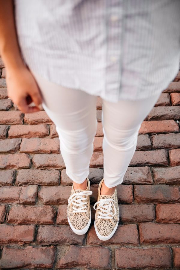Chicago-based fashion blogger Bows & Sequins wearing Old Navy white denim pants and print-mixing leopard-printed sneakers and a striped chambray top.