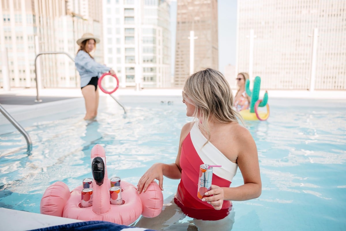 Bows & Sequins hosting a pool party with a flamingo beer float.
