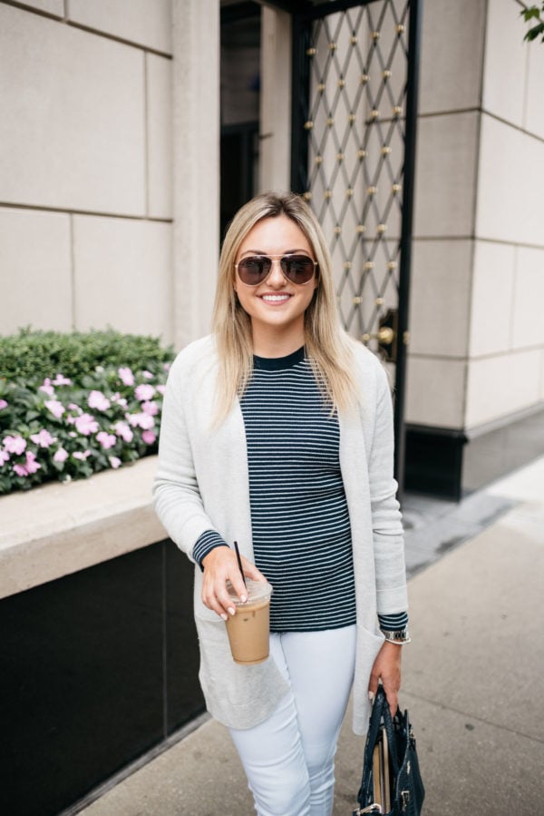 Bows & Sequins wearing a cream cardigan, an Old Navy navy striped sweater, white jeans, and Gucci aviators with a David Yurman bracelet.