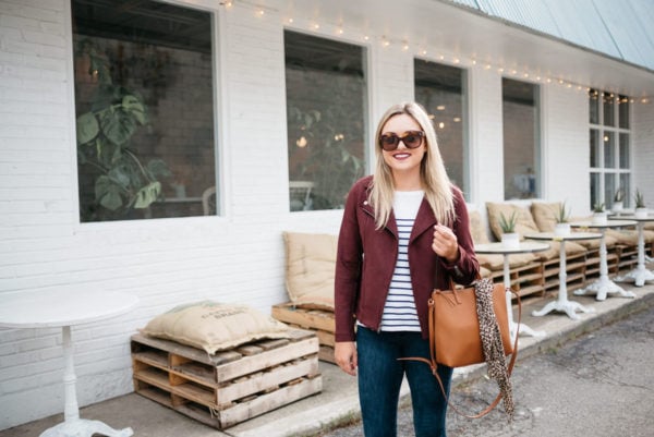Chicago fashion blogger Bows & Sequins wearing a suede moto jacket, Old Navy striped shirt, and Celine sunglasses with a leather bag and leopard scarf.