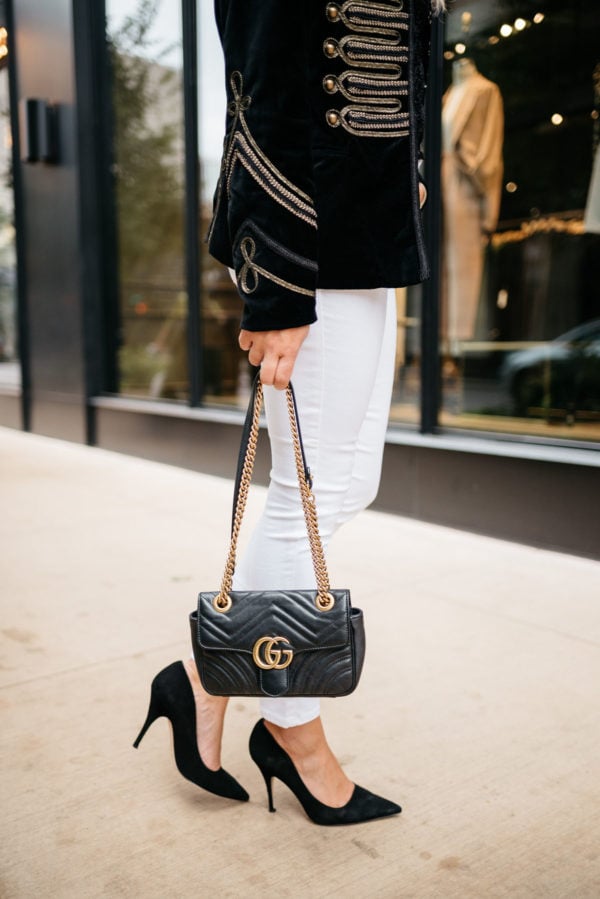 Bows & Sequins wearing Old Navy white jeans, Kate Spade suede pumps, and a velvet blazer with a Gucci Marmont bag.