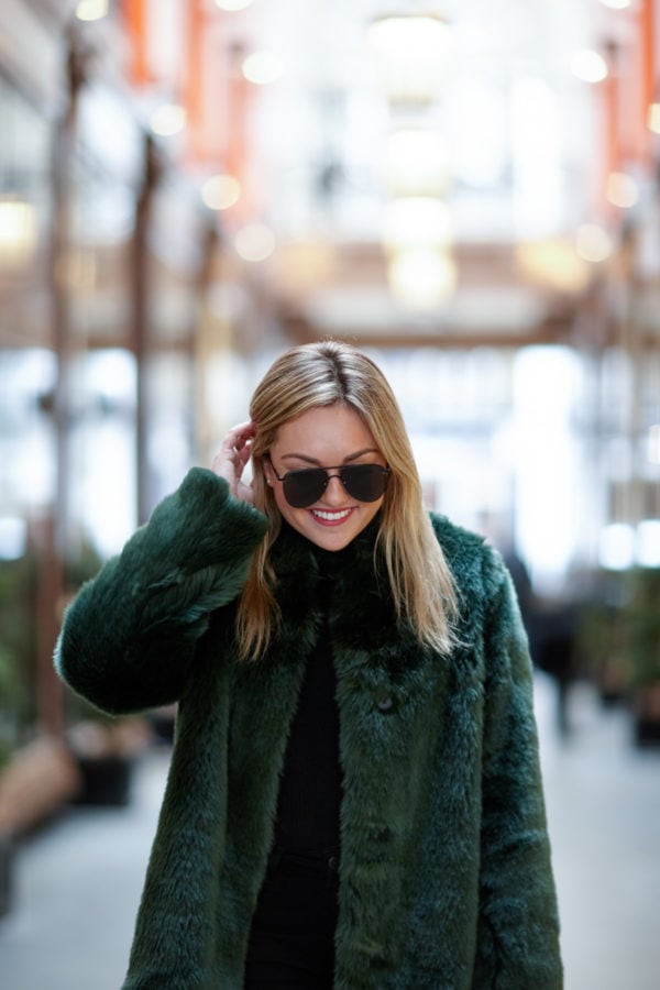 Bows & Sequins wearing a green faux fur coat in London.