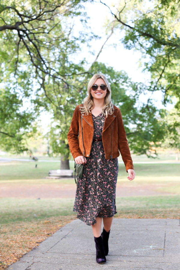 Chicago lifestyle blogger Bows & Sequins wearing a cognac suede jacket, a floral Old Navy dress, and Marc Fisher purple velvet booties.