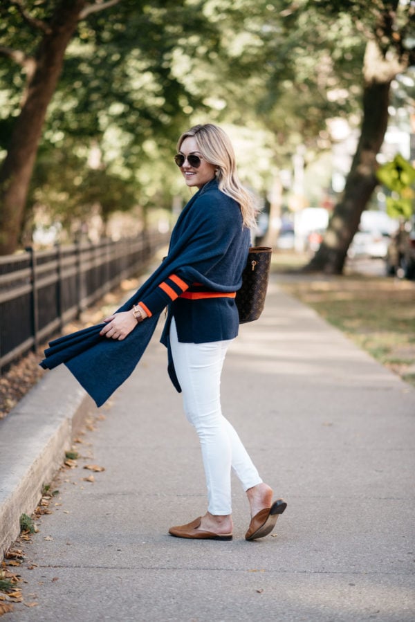 Fashion and lifestyle blogger Bows & Sequins wearing a navy blue cashmere wrap and Old Navy white jeans with Dune London leather loafers and Gucci aviators.