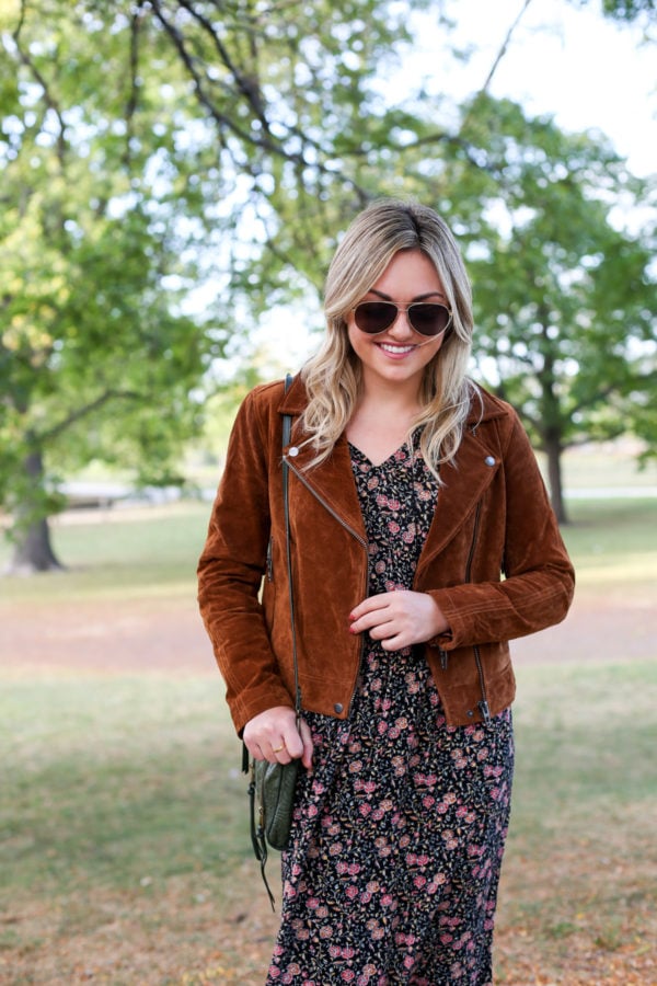 Bows & Sequins wearing a suede jacket with a floral midi dress and a green leather shoulder bag.