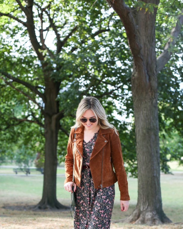 Fashion and travel writer Bows & Sequins styling a Blank NYC cognac suede jacket with an Old Navy floral dress and aviators for fall.