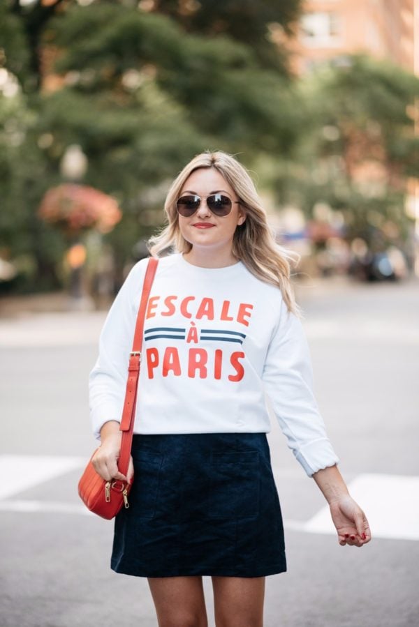Bows & Sequins wearing Gucci aviators, a French Disorder Paris sweatshirt, and an Old Navy blue suede skirt with a Talbots red leather bag.