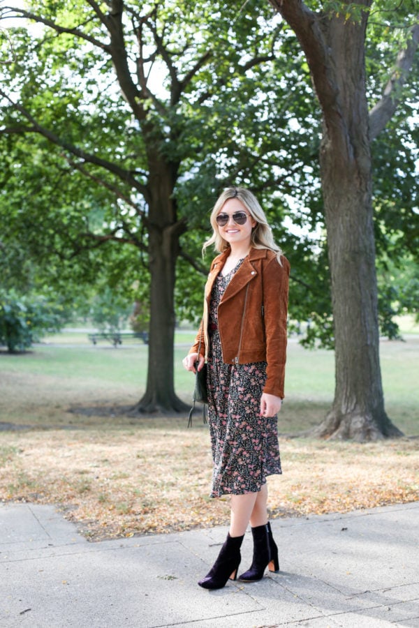 Bows & Sequins wearing a Blank NYC cognac suede jacket, an Old Navy floral midi dress, Marc Fisher purple velvet booties and aviators.