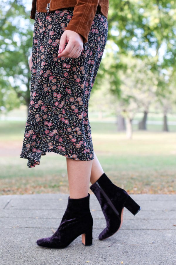 Bows & Sequins wearing a floral midi dress and Marc Fisher purple velvet booties.