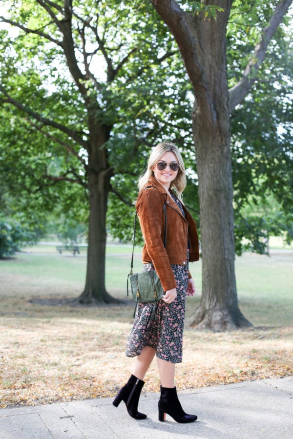 Chicago fashion and style blogger Bows & Sequins wearing a Blank NYC cognac suede jacket, an Old Navy floral midi dress, a Joelle Hawkens green leather shoulder bag, Marc Fisher purple velvet booties and aviators.