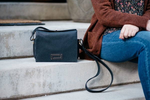 Bows & Sequins styling a Lancel black Pia bag.