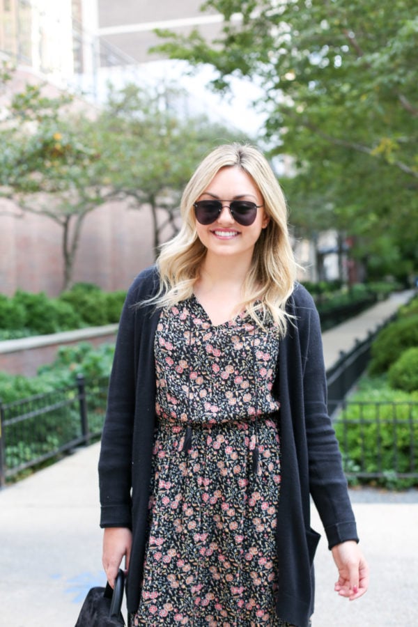 Bows & Sequins wearing Le Specs matte aviators, an Old Navy cardigan, floral dress, and a black leather belt.