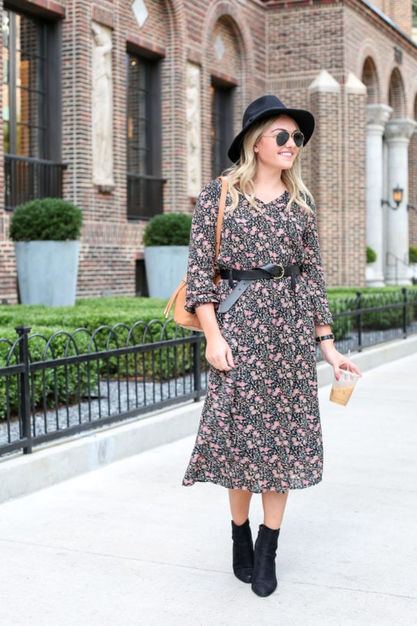 Bows & Sequins wearing an Old Navy fall floral midi dress with a Madewell leather belt, black hat, a Kate Spade watch, and ankle booties.