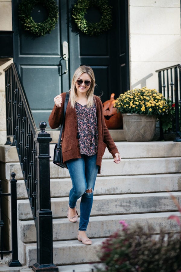 Chicago-based fashion-focused blogger Bows & Sequins wearing Gucci aviators, a slouchy sweater, an Old Navy floral blouse, Old Navy Rockstar jeans, Margaux Ballerina ballet flats, and a Lancel black Pia bag with NARS Audacious lipstick in 'Anna'.