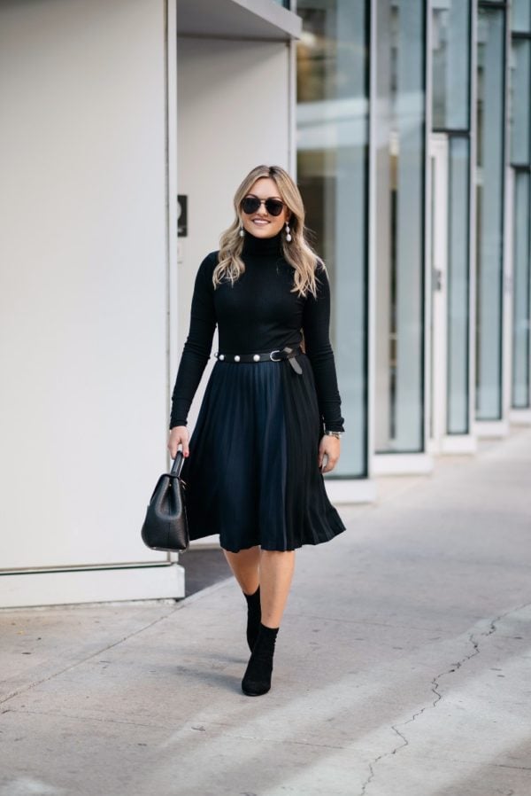 Bows & Sequins wearing a ribbed turtleneck bodysuit with a pleated midi skirt, a Claudie Pierlot pearl studded belt, ankle booties, and a Polene bag.