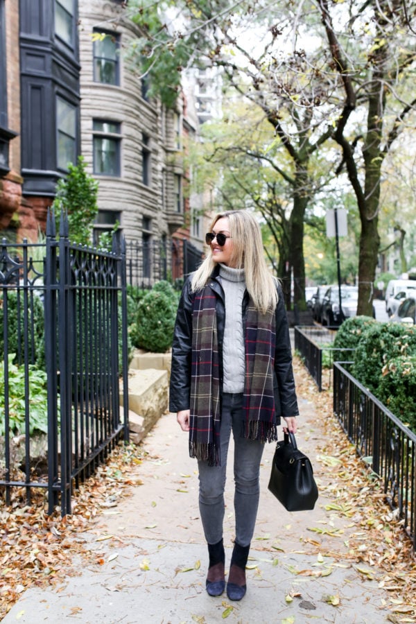 Chicago blogger Jessica Sturdy wearing Le Specs matte aviators, a black Barbour jacket, tartan scarf, grey jeans, and patchwork booties with a Polene bag.