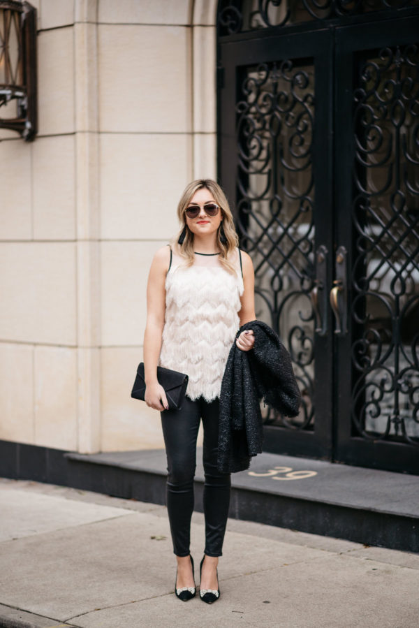 Jessica Sturdy wearing Gucci aviators, a Sail to Sable fringe tank, a sparkly tweed coat, Express black denim waxed jeans, and Kate Spade suede bow pumps with Hart tassel earrings and an Old Navy clutch.