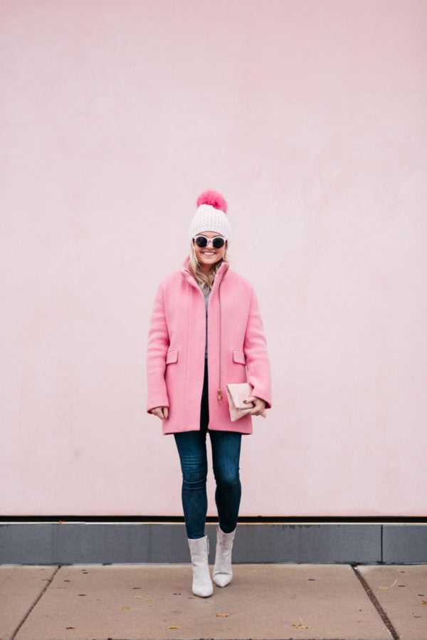 Jessica Rose Sturdy wearing a Kyi Kyi pink pom pom hat, a J.Crew winter coat, Rag & Bone jeans, and Linea Paolo suede ankle booties via Nordstrom.