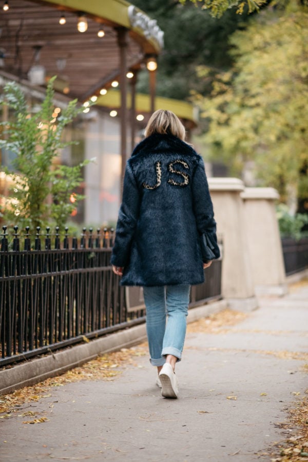Jessica Rose Sturdy wearing a leopard-print monogrammed faux fur Miranda Dunn coat with Vineyard Vines boyfriend jeans and Sezane Paris Jack leather sneakers.
