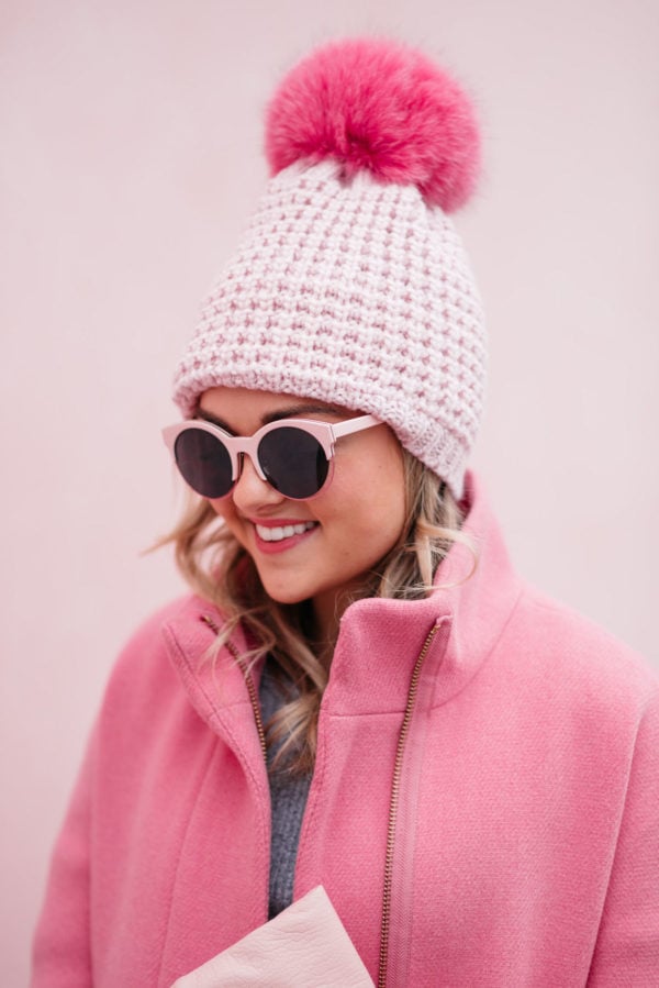 Chicago fashion and lifestyle blogger Bows & Sequins wearing pink sunglasses, a pink fur pom pom hat and a J.Crew cocoon coat.