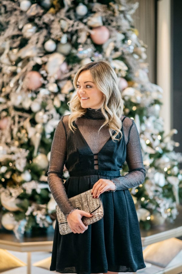 Jessica Sturdy wearing a Free People dress with a sparkle bodysuit, Loren Hope earrings, and a Milly metallic clutch.