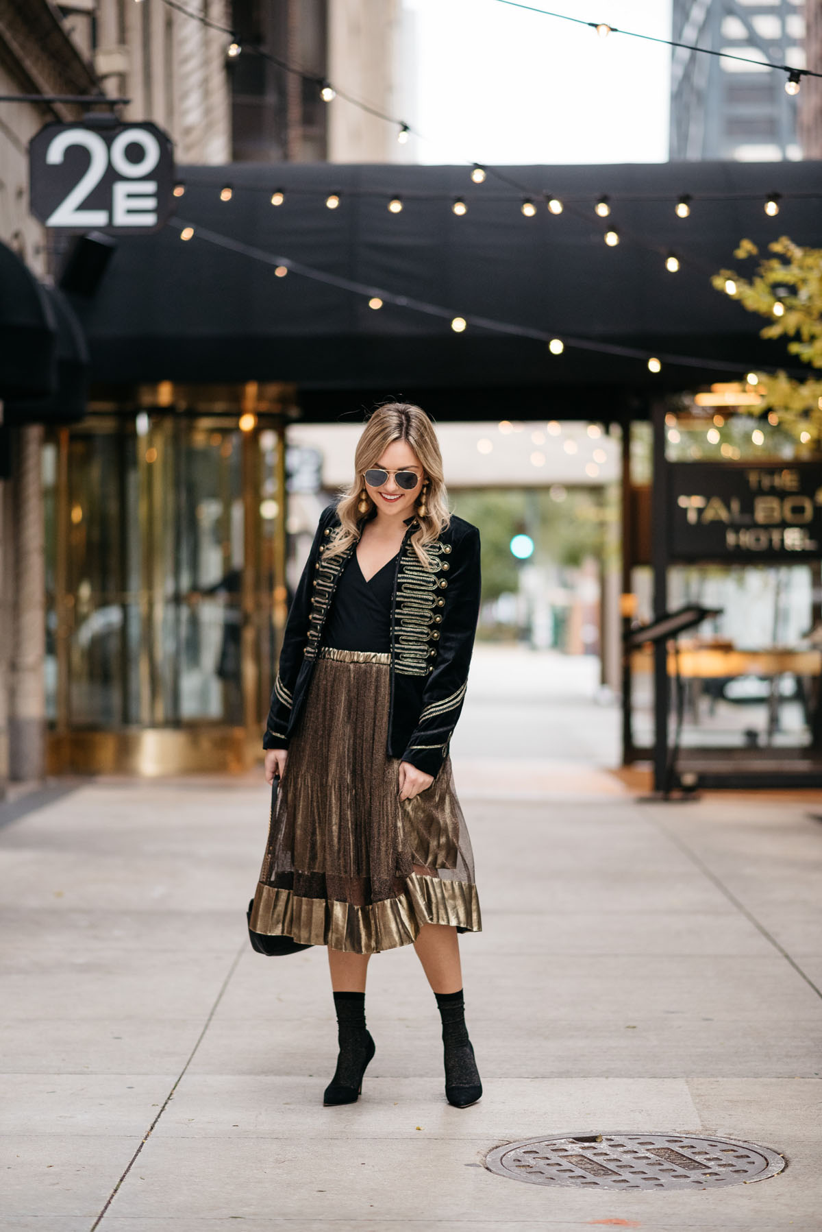 Chicago blogger Jessica Rose Sturdy wearing Ray-Ban aviators, Blank NYC black velvet and gold embroidered band jacket, J.Crew bodysuit, gold midi skirt, black & gold shimmer socks, and Kate Spade black suede pumps with Kenneth Jay Lane gold earrings and a Gucci Marmont black leather bag.