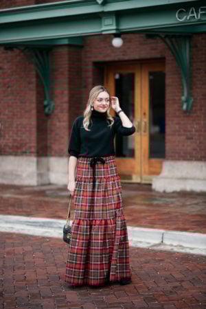Jessica Sturdy sharing how she styled her J.Crew plaid maxi skirt with a black turtleneck and sparkly Loren Hope earrings.