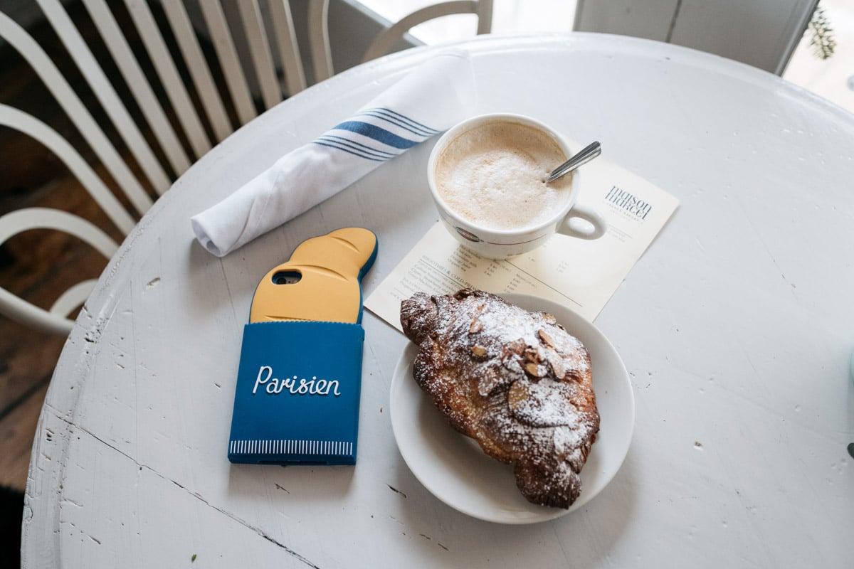 Blogger Jessica Sturdy with a French croissant phone case at the Maison Marcel cafe in Chicago.
