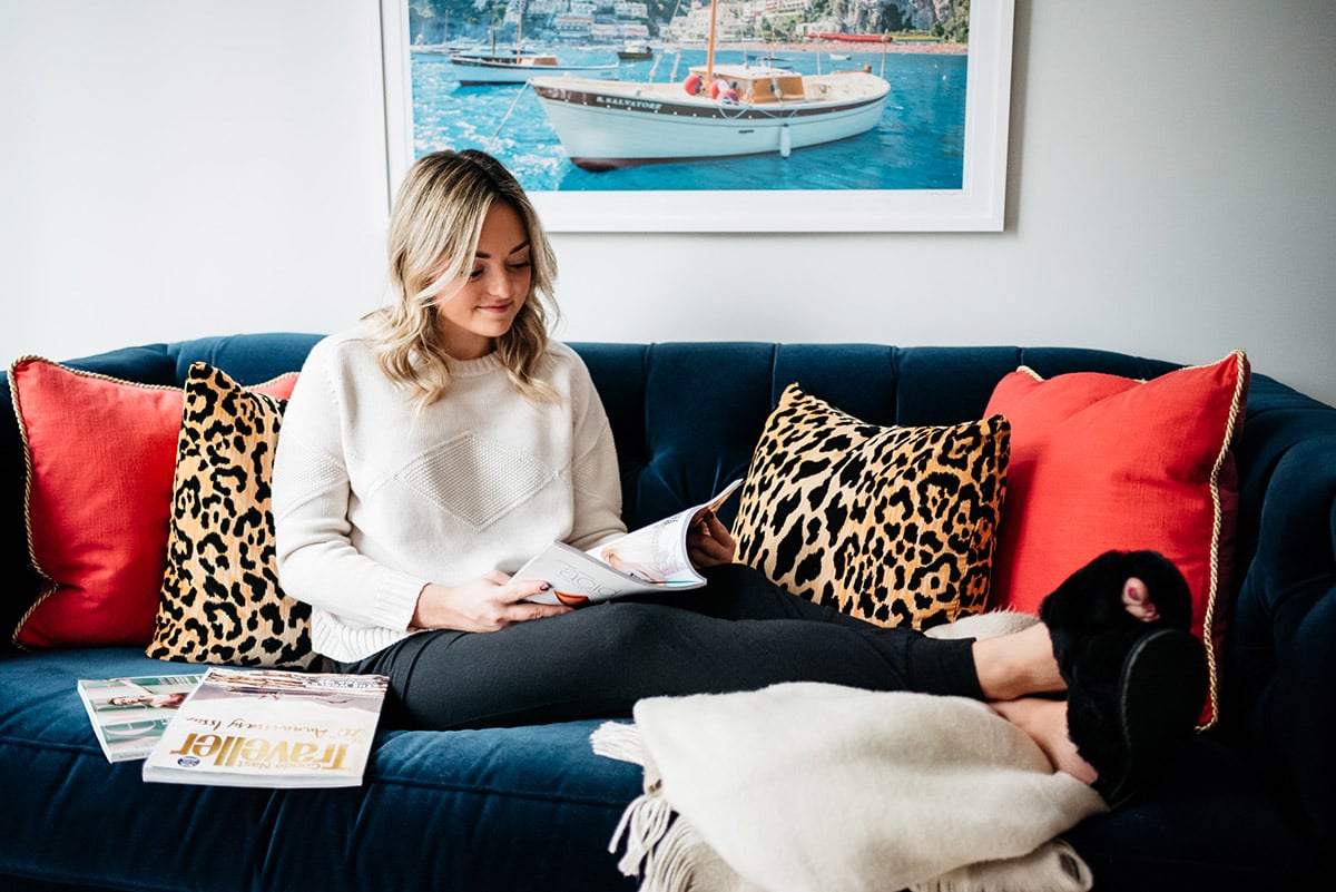 Jessica Sturdy reading on the couch in her living room in Chicago.