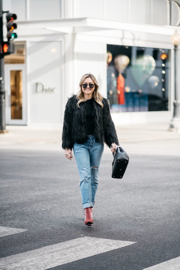 Chicago fashion blogger Jessica Sturdy sharing her winter uniform: black faux fur coat, Old Navy ribbed sweater, Levi's 501 boyfriend jeans, Robert Clergerie pink velvet booties, Polene Paris top handle bag, and Le Specs matte black aviators.