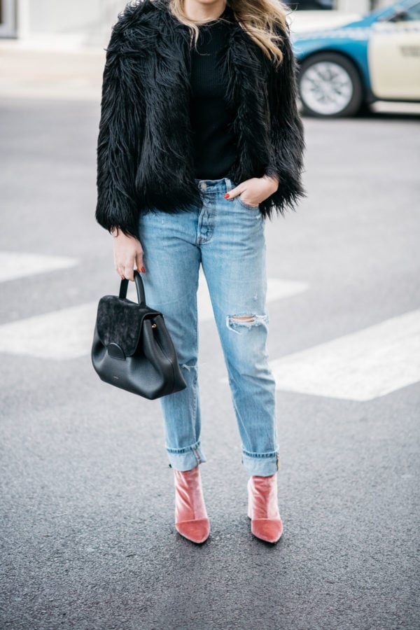 Chicago blogger Jessica Sturdy of Bows & Sequins wearing a 1.State black faux fur coat, Old Navy black ribbed sweater, Levi's 501 boyfriend jeans, and Robert Clergerie pink velvet booties with a Polene Paris top-handle bag.