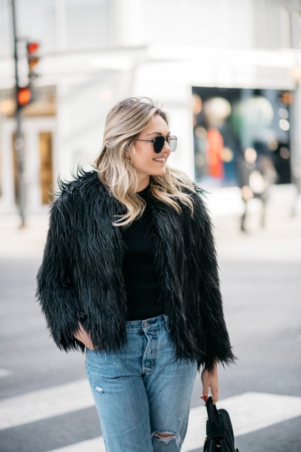 Jessica Sturdy of Bows & Sequins wearing Le Specs aviators, 1.State black faux fur coat, Old Navy ribbed sweater and Levi's 501 boyfriend jeans.