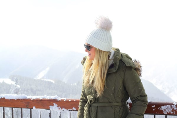 Jessica Sturdy wearing an olive green puffer coat in Aspen.