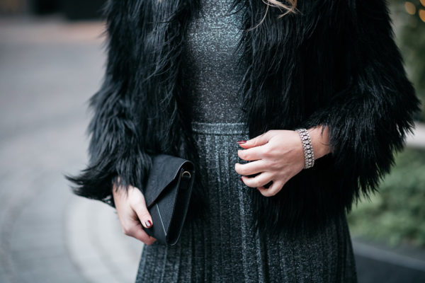 Jessica Sturdy styling a black fur coat and silver dress.