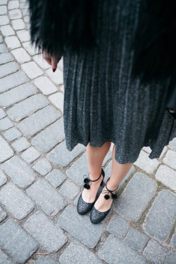 Jessica Sturdy wearing Kate Spade glitter pom-pom ankle strap heels.