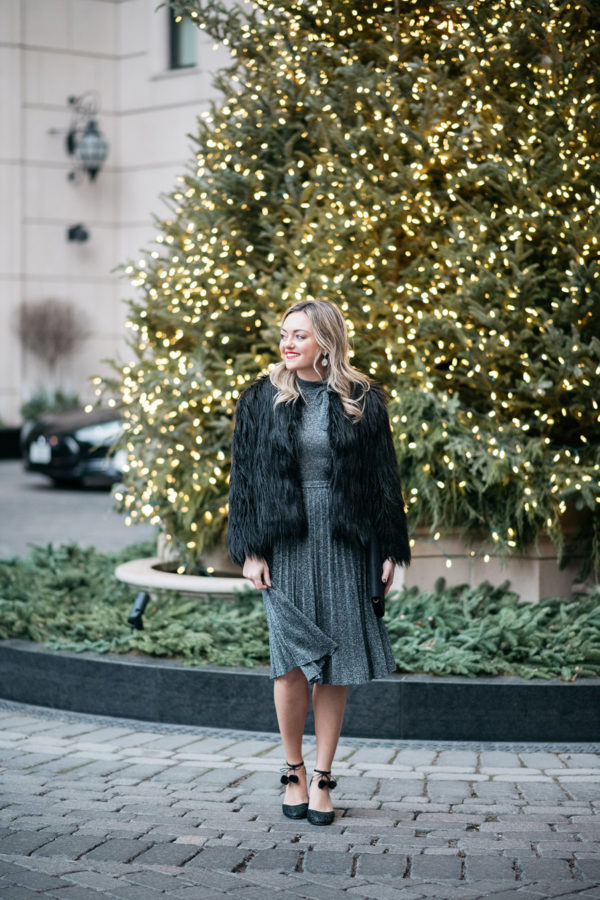 Jessica Sturdy wearing a silver dress in front of the Christmas tree at the Waldorf Astoria in Chicago.