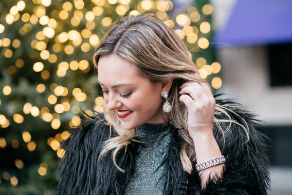 Jessica Sturdy wearing Loren Hope earrings and a black fur coat.